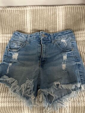 High-Rise Distressed Denim Shorts in Light Blue